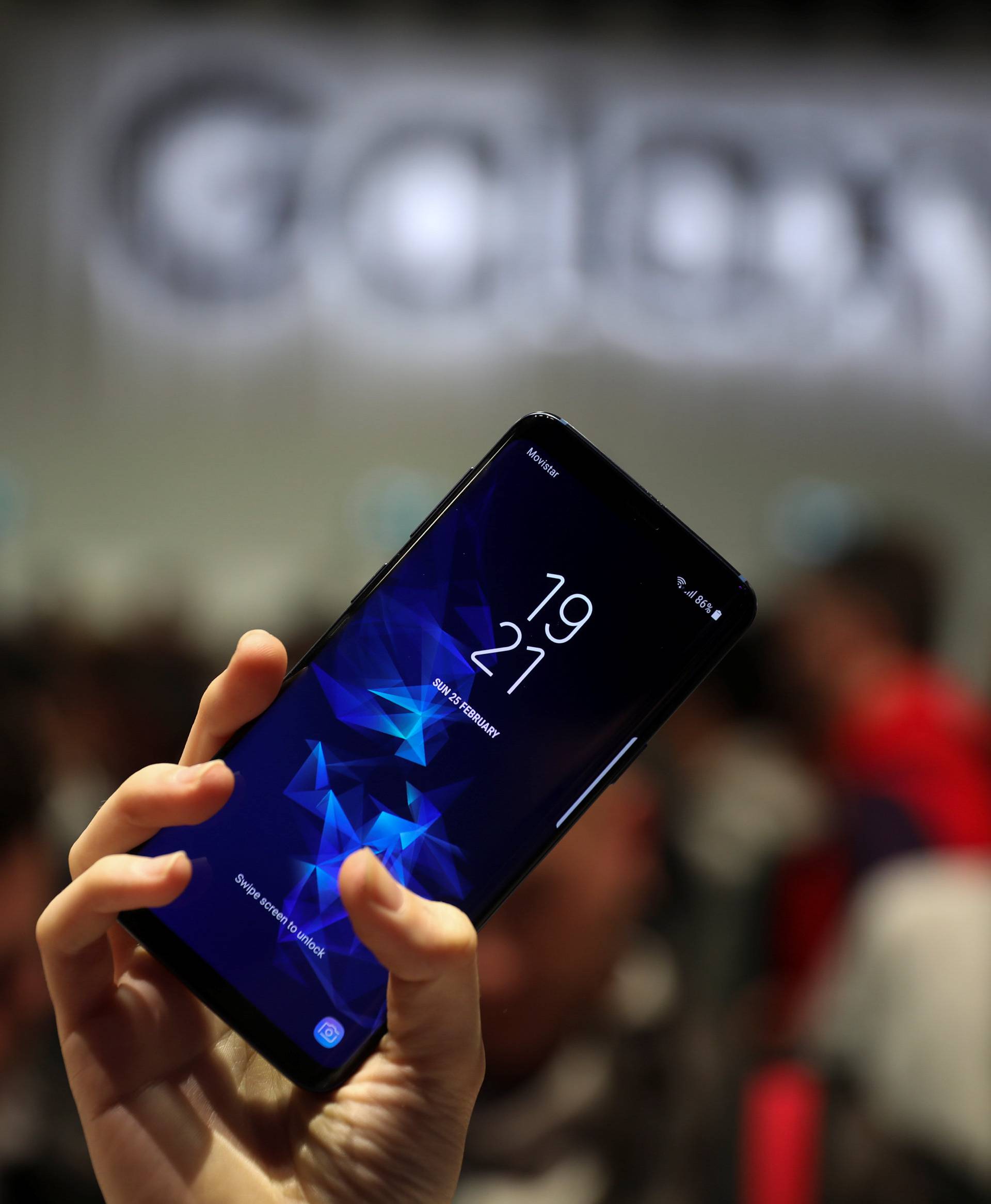 A hostess shows up Samsung's new S9 device after a presentation ceremony at the Mobile World Congress in Barcelona
