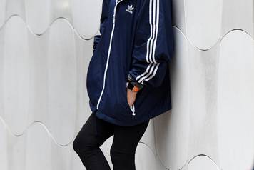 EXCLUSIVE: Anna Kournikova is dressed down in an Adidas jacket and Croc's rain boots as she waits for her car in Miami