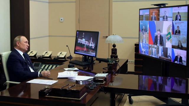 Russian President Vladimir Putin attends a meeting with government members via a video link at the state residence outside Moscow