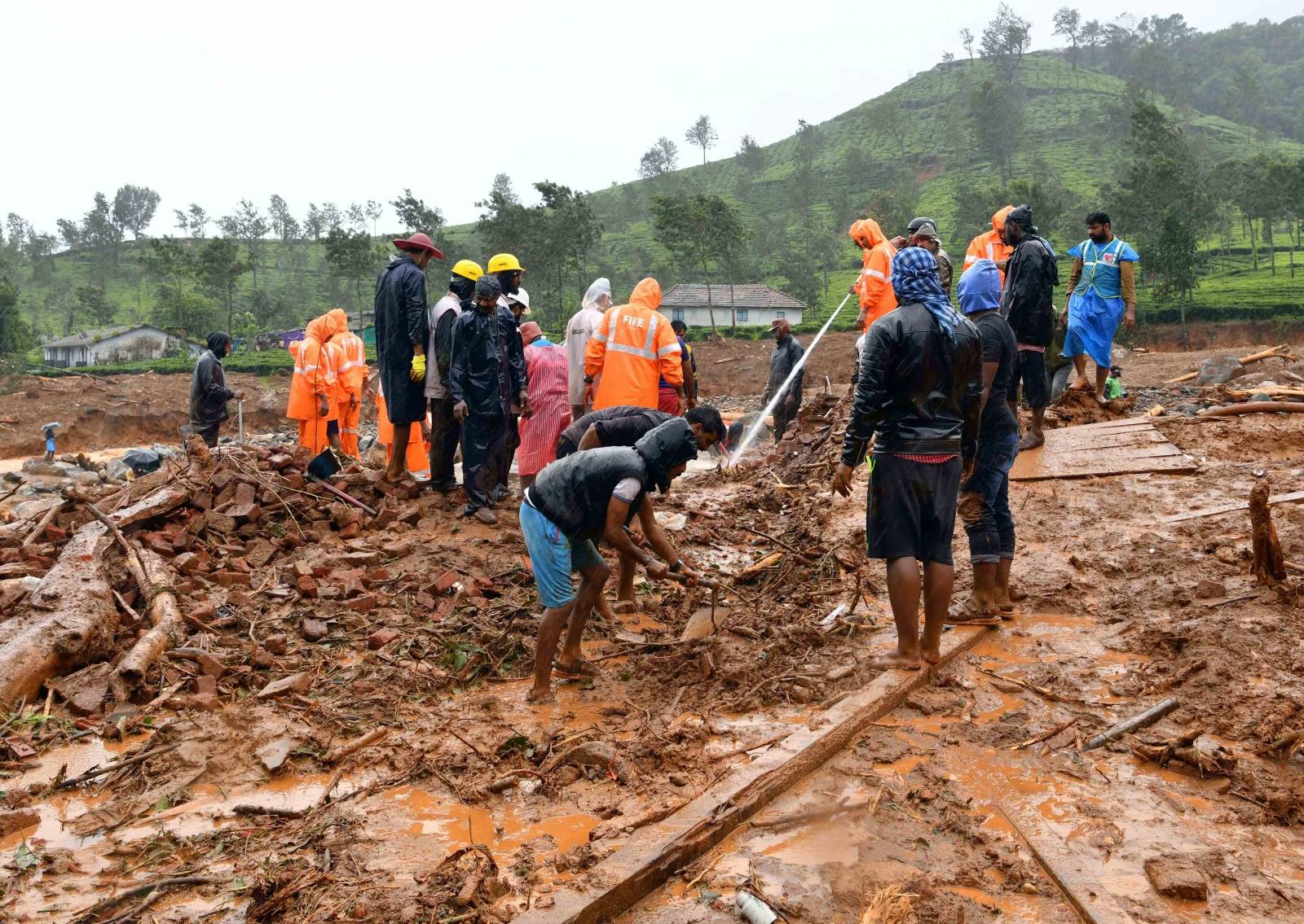 Rescuers remove debris as they search for victims of a landslide caused by torrential monsoon rains in Meppadi in Wayanad district