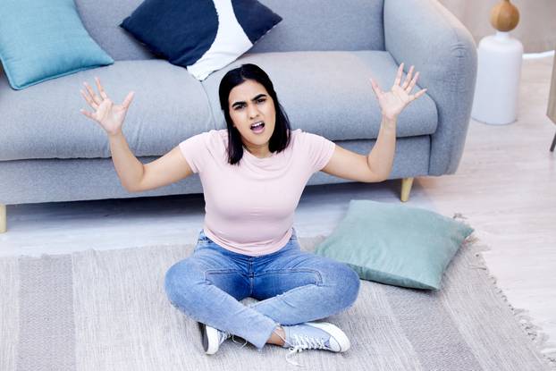 I cant do anymore chores. a young woman cleaning her lounge at home.