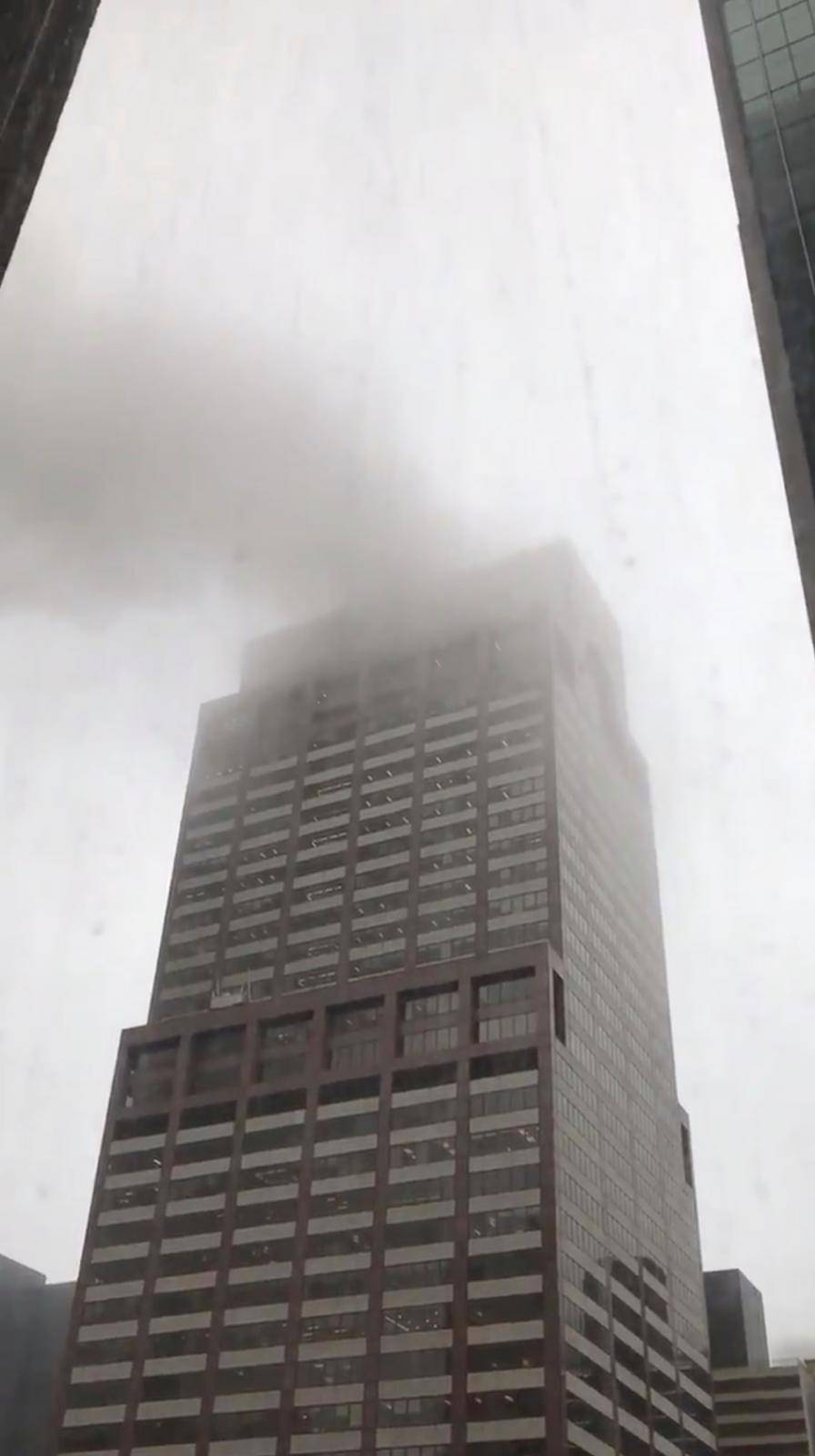 Smoke is seen rising from a building after a helicopter crash in New York City