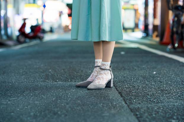 Young woman posing in Tokyo city at night