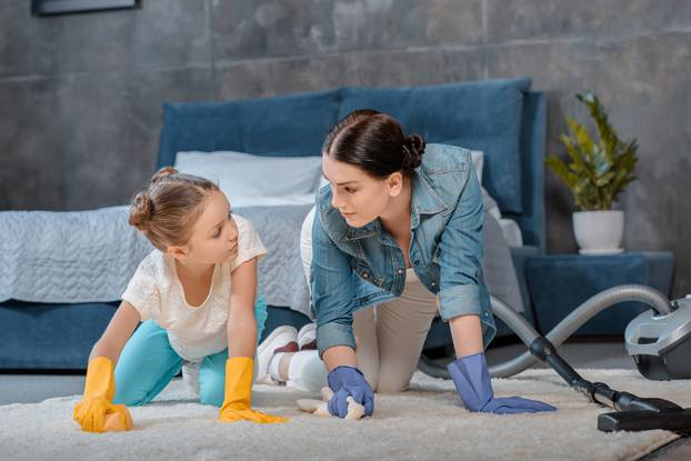 Mother,And,Daughter,In,Protective,Gloves,Cleaning,Carpet,And,Looking