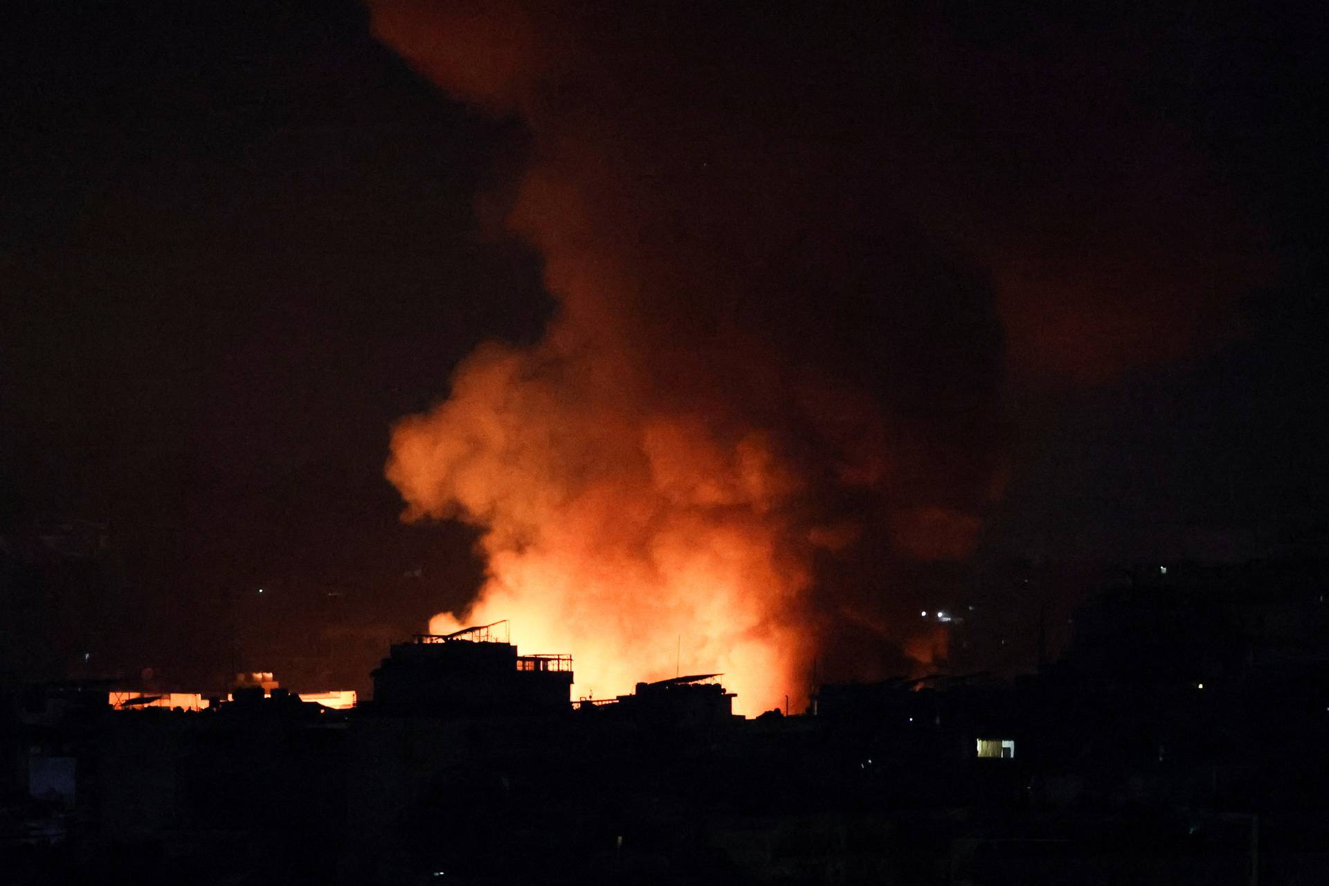 Smoke billows over Beirut's southern suburbs, as seen from Sin El Fil