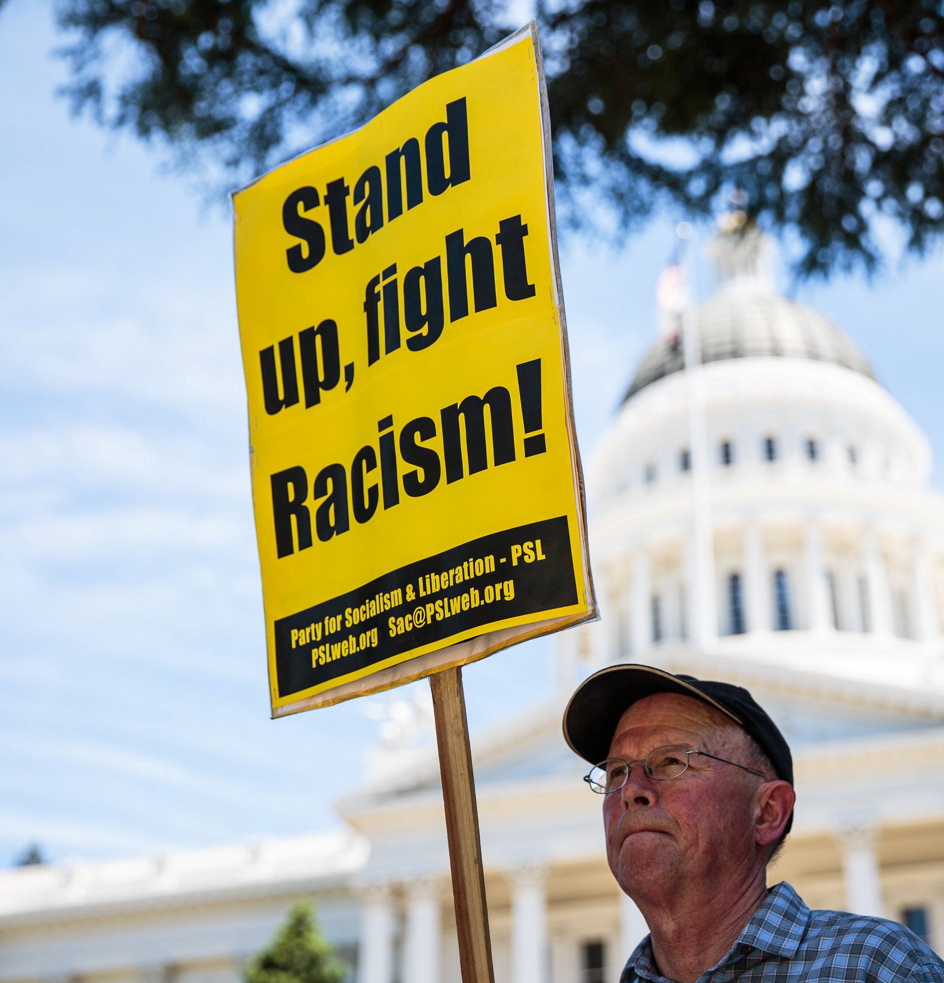 Richard Becker protests after multiple people were stabbed during a clash between neo-Nazis holding a permitted rally and counter-protestors on Sunday at the state capitol in Sacramento.