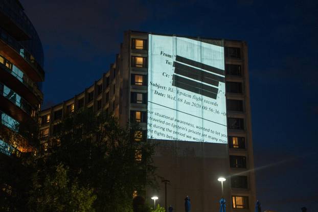 Documents and photos of Jeffrey Epstein and U.S. President Trump projected onto Hilton ahead of WHCA Gala, in Washington, D.C.