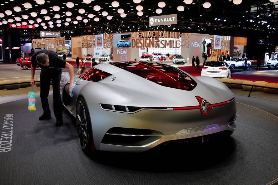 A man cleans the concept car Renault Trezor displayed on media day at the Paris auto show, in Paris
