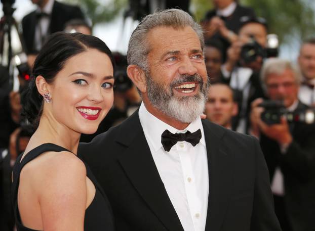 Actor Mel Gibson and partner Rosalind Ross pose on the red carpet as they arrive at the closing ceremony of the 69th Cannes Film Festival in Cannes