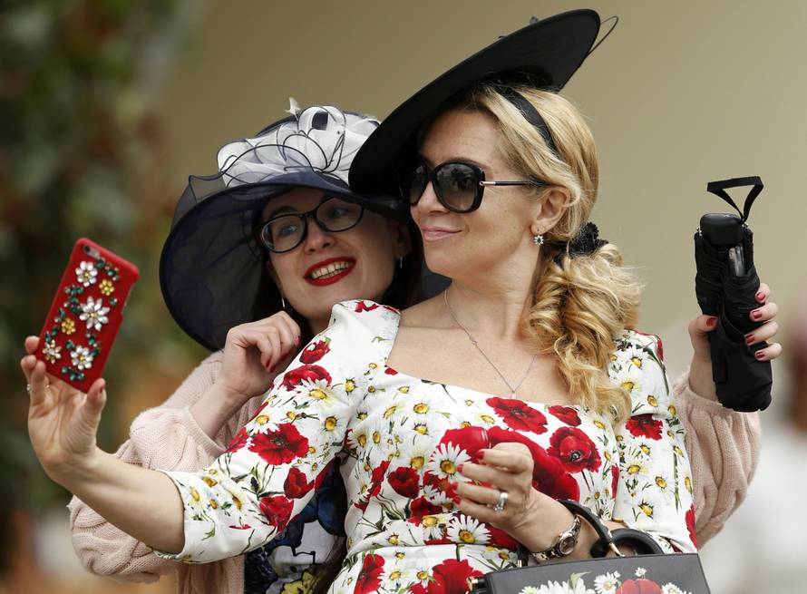 Britain Horse Racing Ladies Day Racegoer wears hat