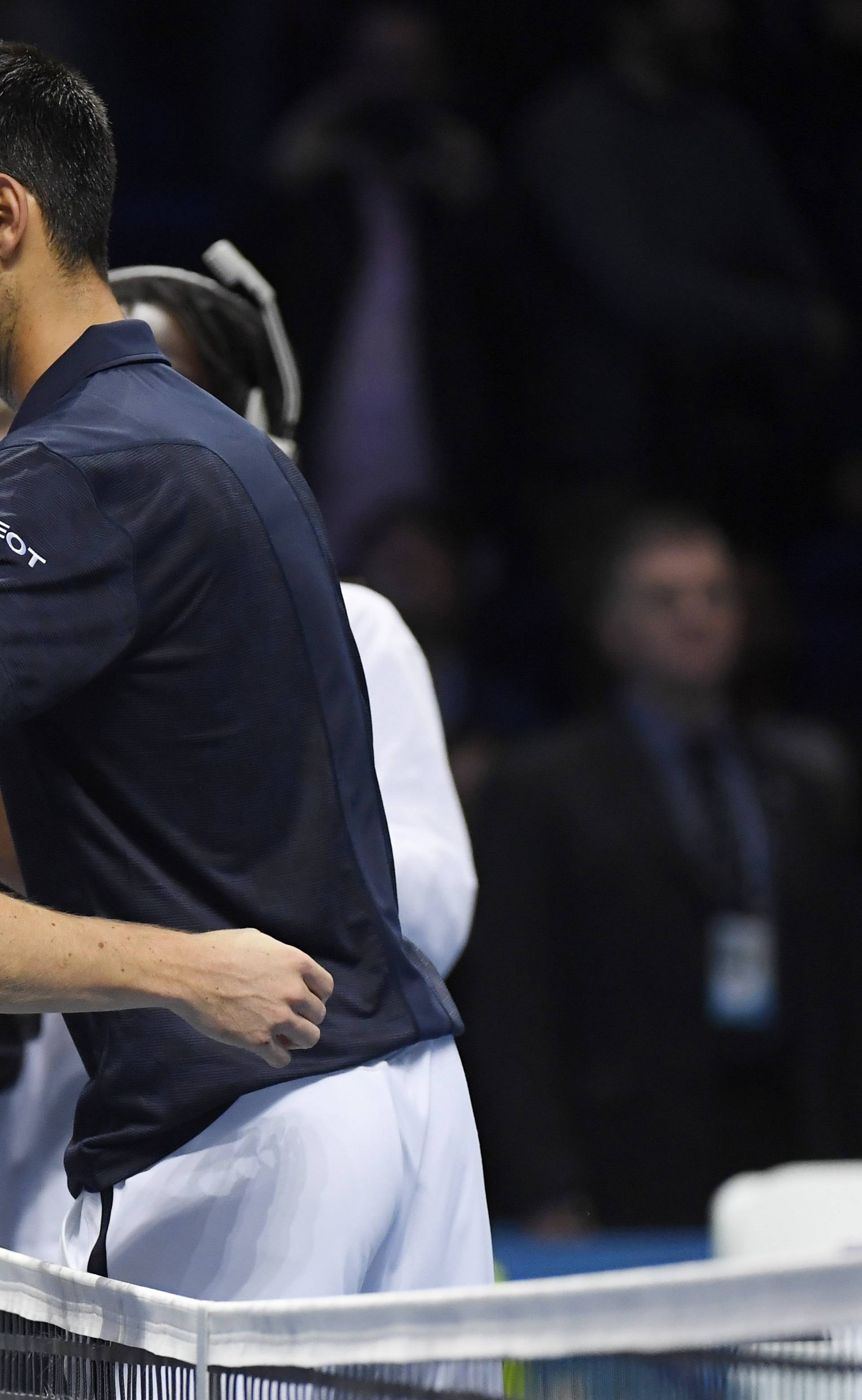 Serbia's Novak Djokovic celebrates winning his round robin match with Belgium's David Goffin