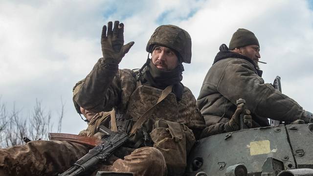 Ukrainian service members ride a BMP-1 infantry fighting vehicle in Bakhmut