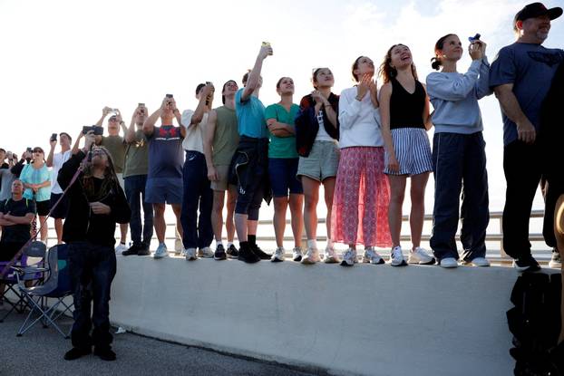 FILE PHOTO: People gather to watch the launch of the Artemis II mission in Titusville