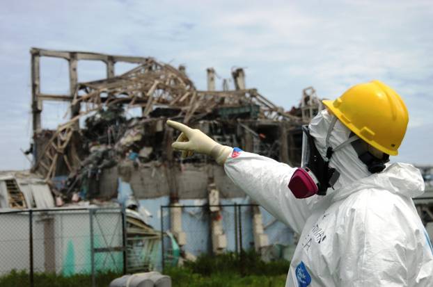 FILE PHOTO: IAEA fact-finding team leader Mike Weightman examines Reactor Unit 3 at the Fukushima Daiichi Nuclear Power Plant