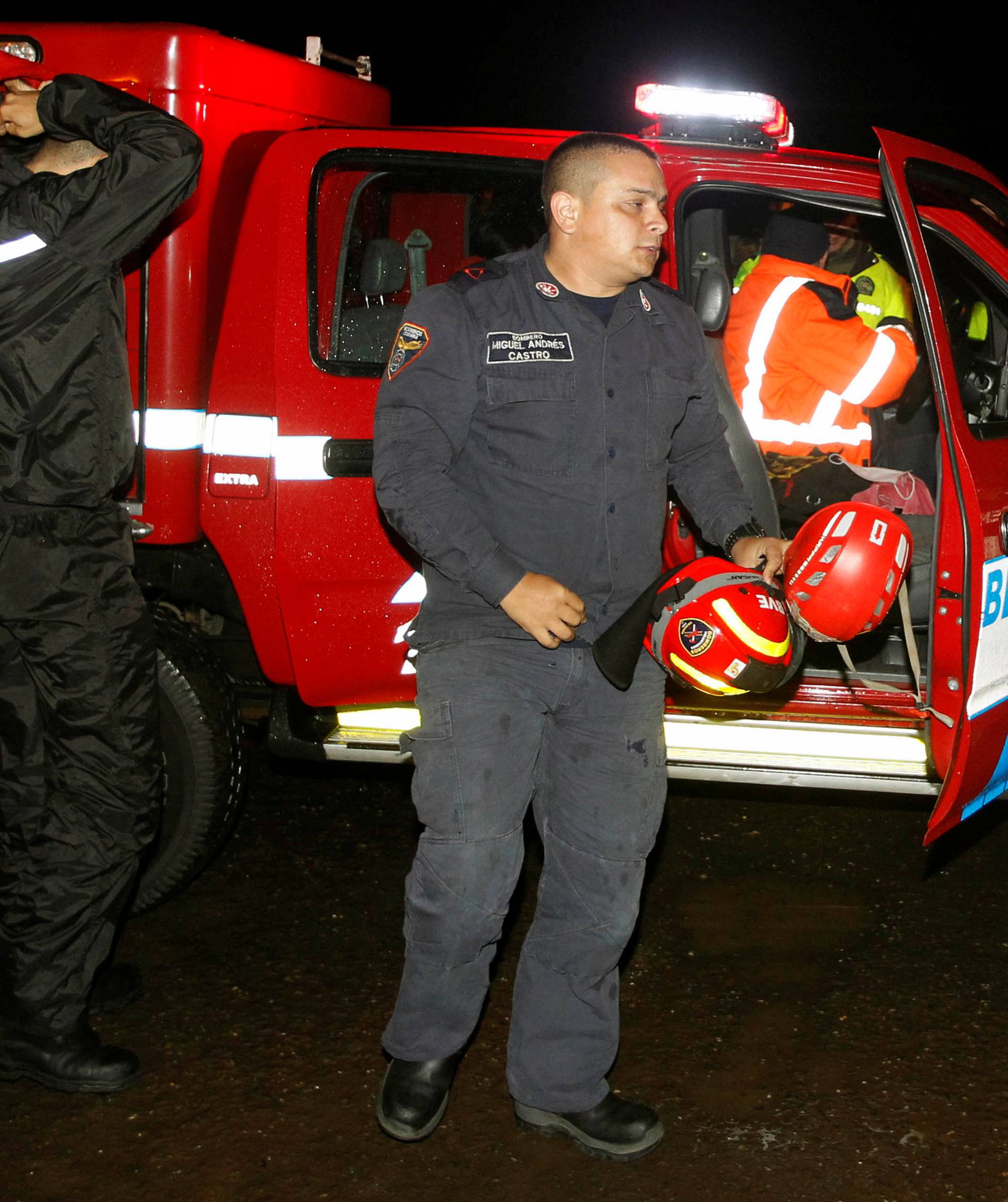 Rescue workers react after searching for the victims of a plane that crashed in the Colombian jungle with the Brazilian football team Chapecoense near Medellin