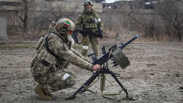 Zamid Chalaev regiment commander from Chechen Republic fires an automatic grenade launcher during fighting in Ukraine-Russia conflict in the city of Mariupol