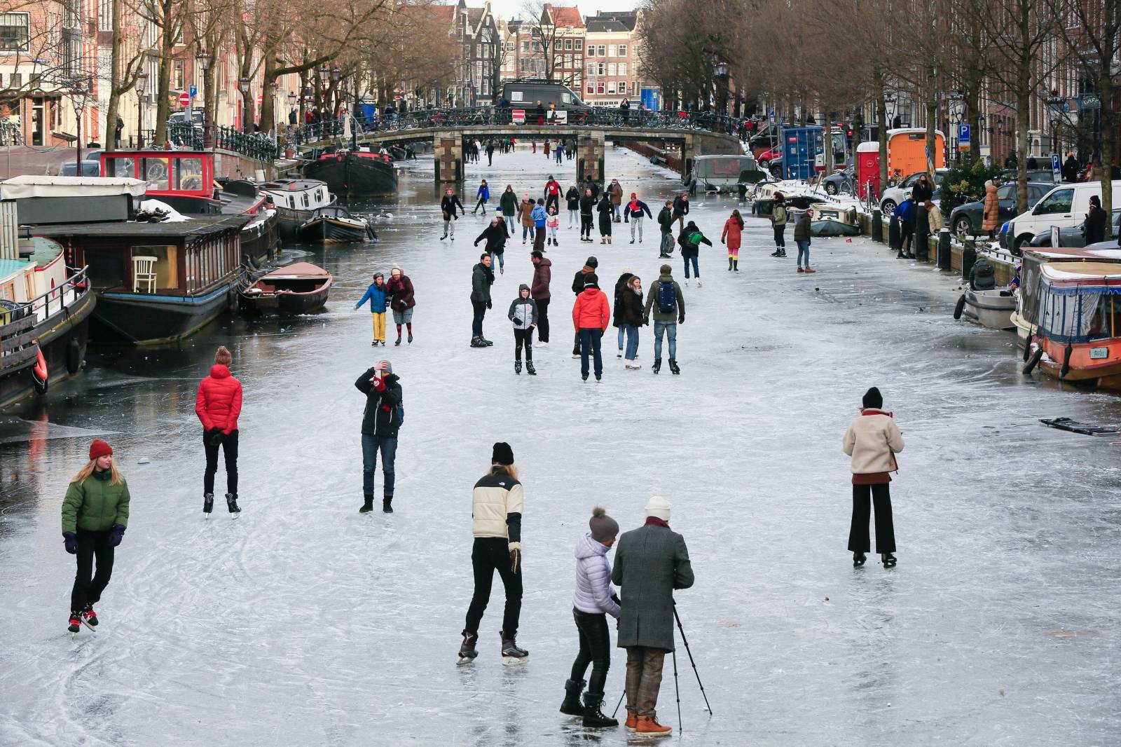 People ice skate during a cold snap across the country at the canals in Amsterdam