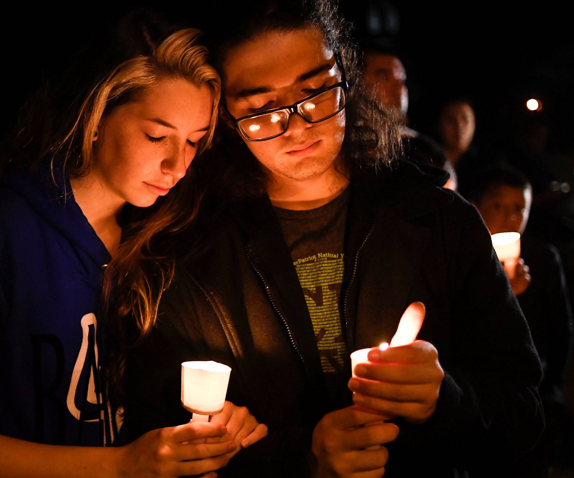 Local residents take part in a vigil for victims of a mass shooting in Sutherland Springs, Texas