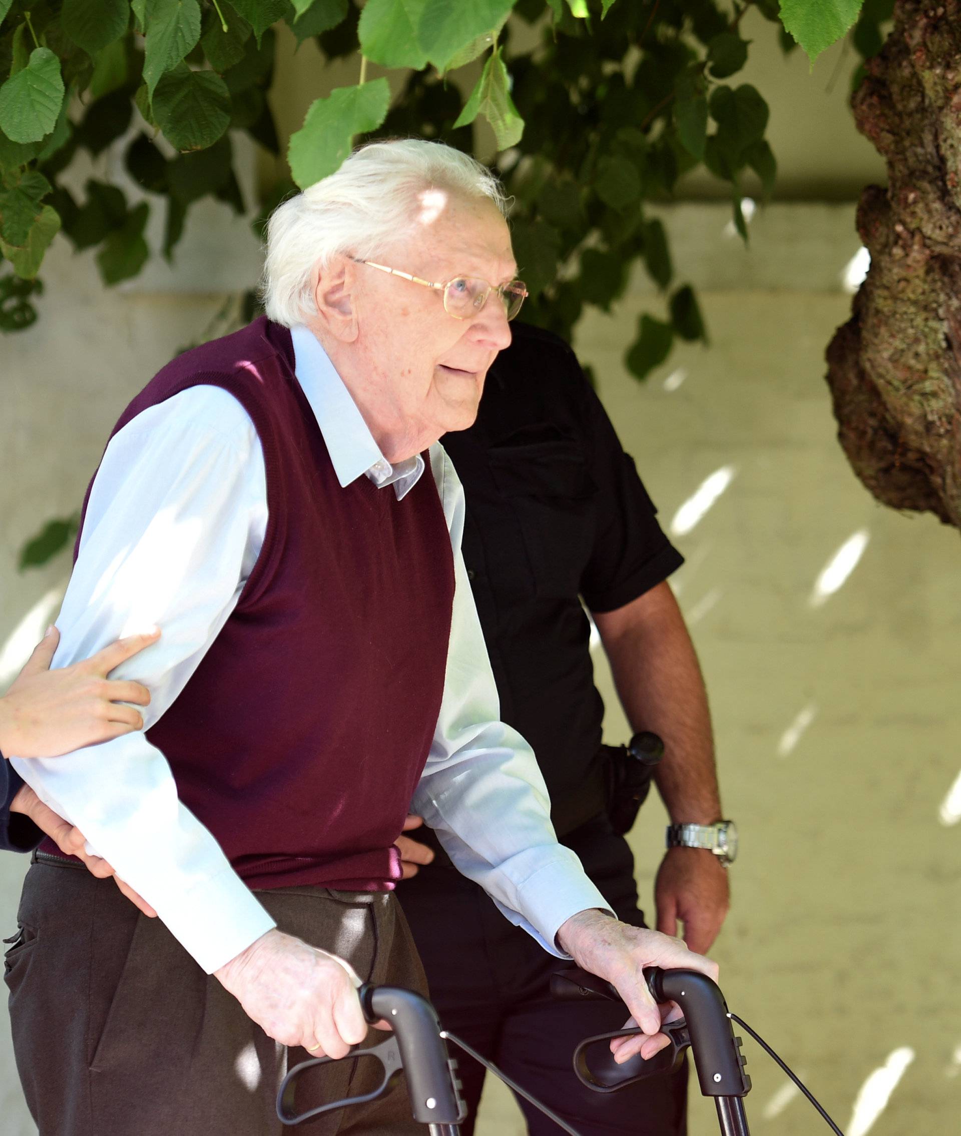 FILE PHOTO: Groening, defendant and former Nazi SS officer dubbed the "bookkeeper of Auschwitz" leaves the court after the announcement of his verdict in Lueneburg