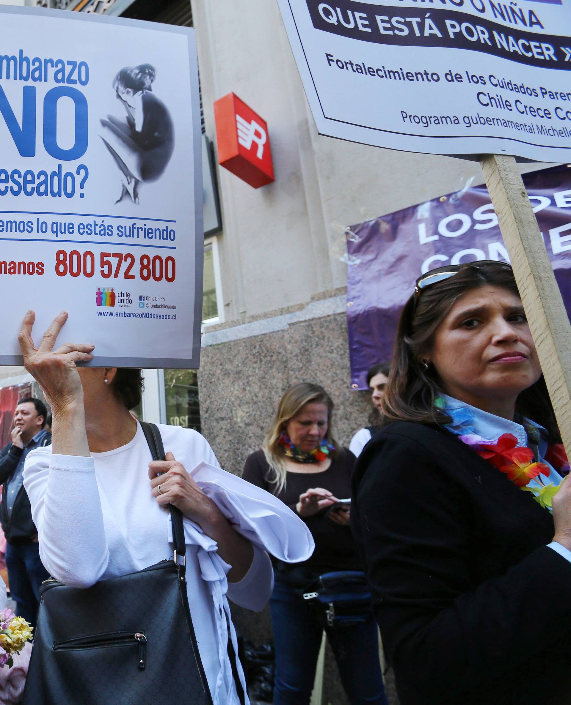 A demonstrator against abortion hold a placard during a rally in Santiago
