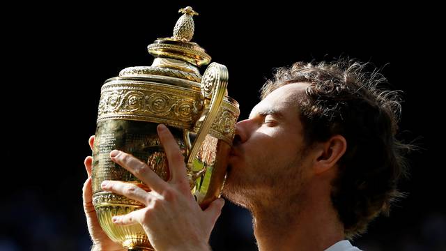 FILE PHOTO: Britain's Andy Murray kisses the Wimbledon trophy at All England Lawn Tennis & Croquet Club, Wimbledon, England - 10/7/16