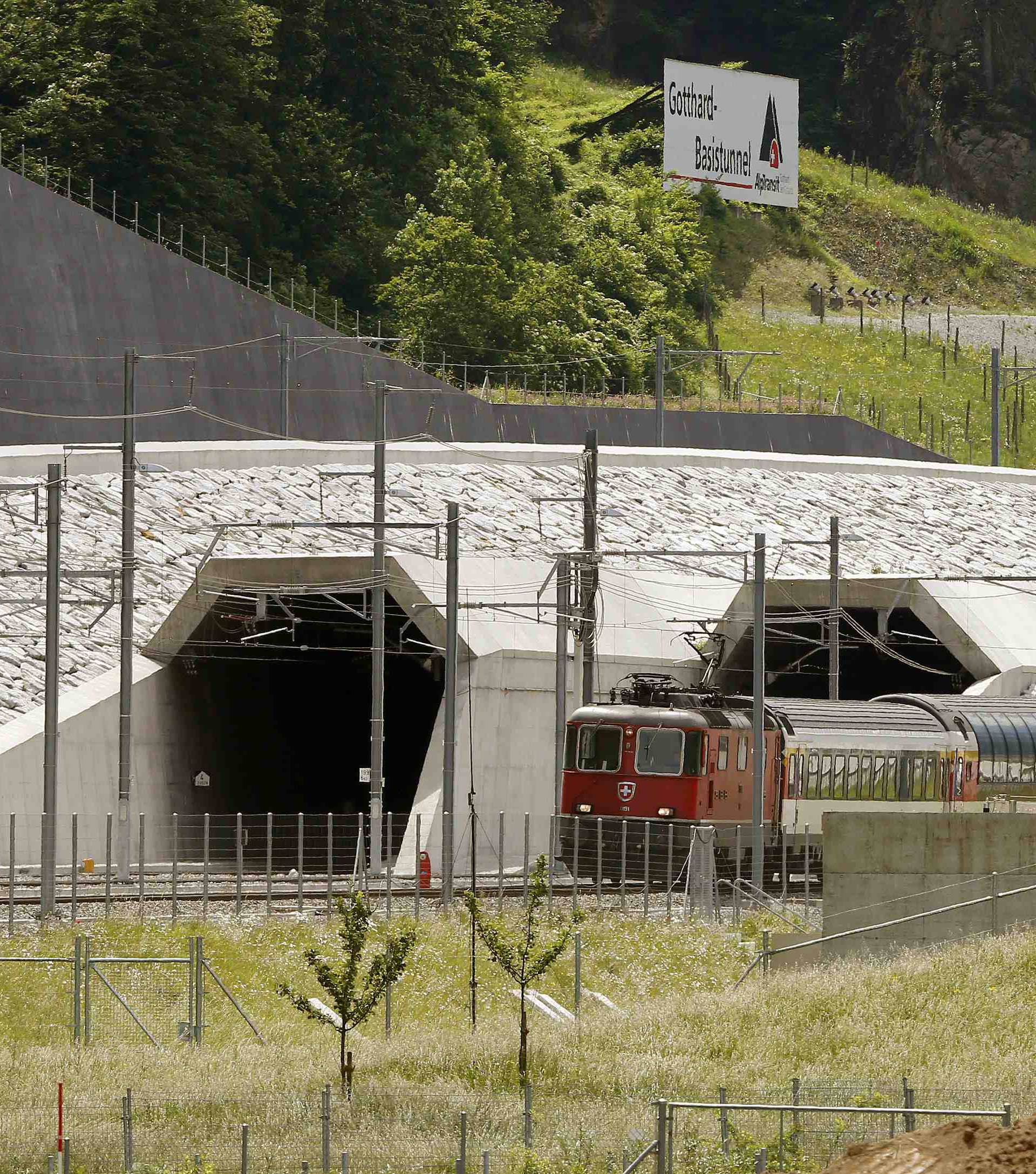 A train drives past the northern gates of the NEAT Gotthard Base Tunnel near Erstfeld
