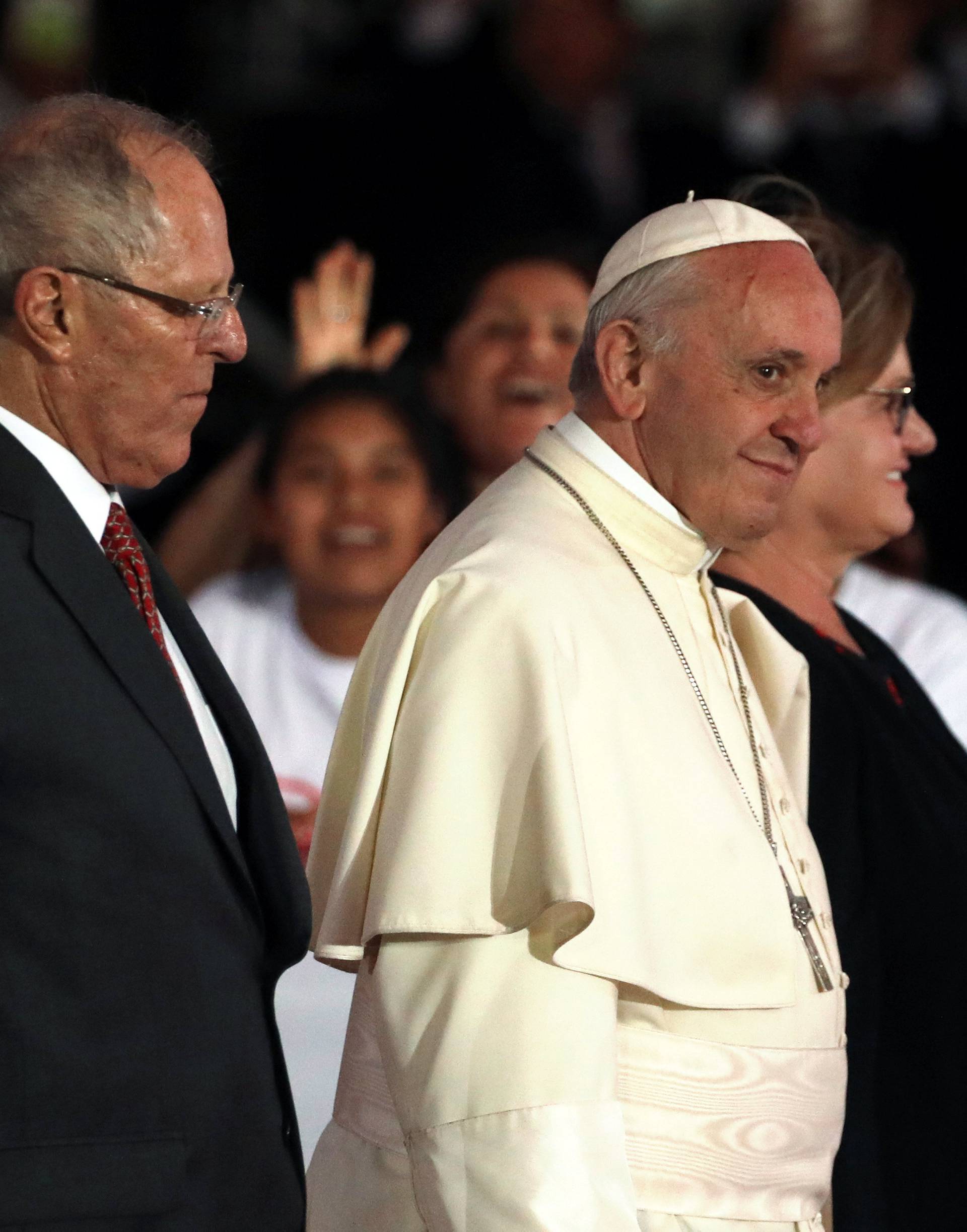 Peru's President Kuczynski, Pope Francis and the first lady walk together during the Pope's farewell ceremony, in Lima