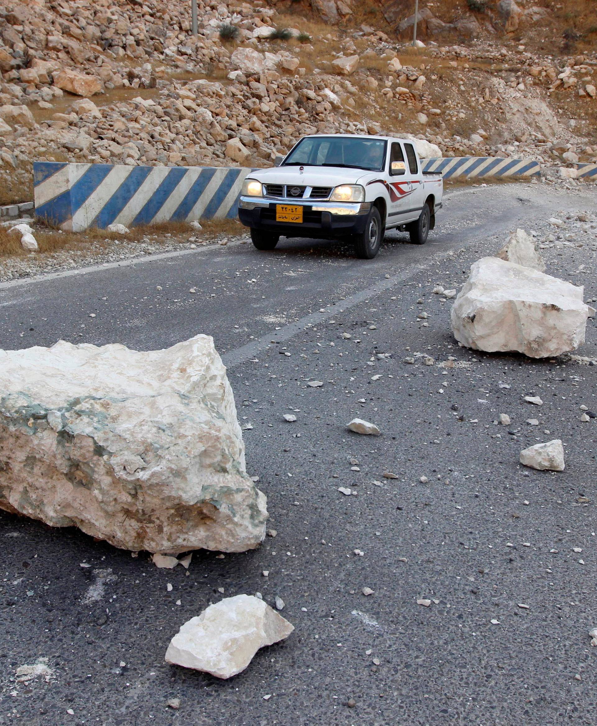 Rocks are seen on the road after an earthquake near the Darbandikhan Dam