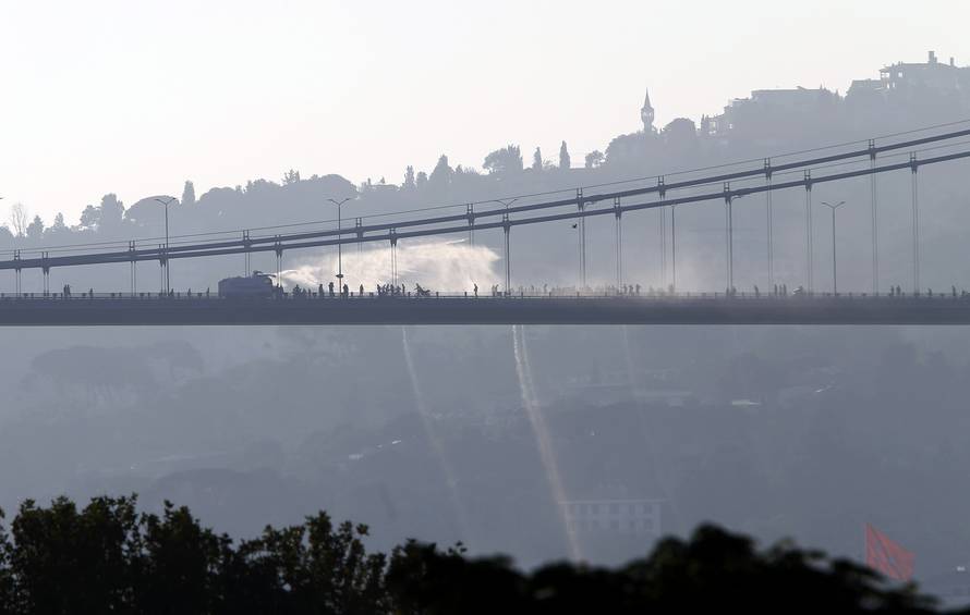 A police armored vehicle uses a water cannon to disperse anti-government forces on Bosphorus Bridge in Istanbul