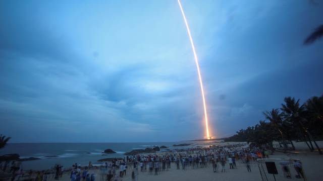 People watch the launch of the Long March-5 Y2 rocket from Wenchang Satellite Launch Center in Wenchang