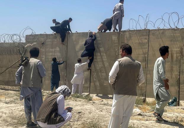 Men try to get inside Hamid Karzai International Airport in Kabul