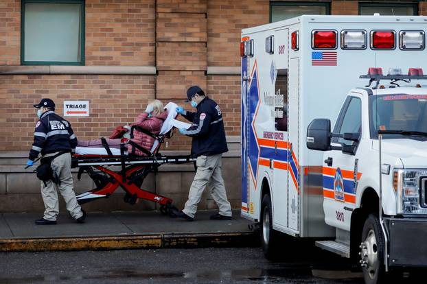 Paramedics take a patient in to an emergency center at Maimonides Medical Center during the outbreak of the coronavirus disease (COVID-19) in the Brooklyn, New York
