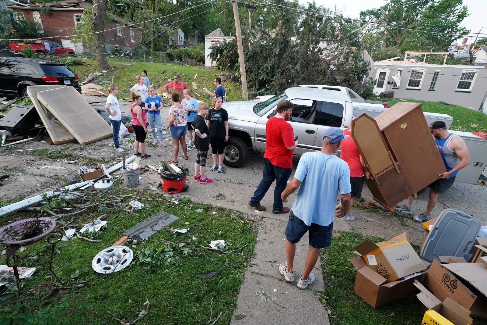 People rescue items from a home following a tornado in Jefferson City