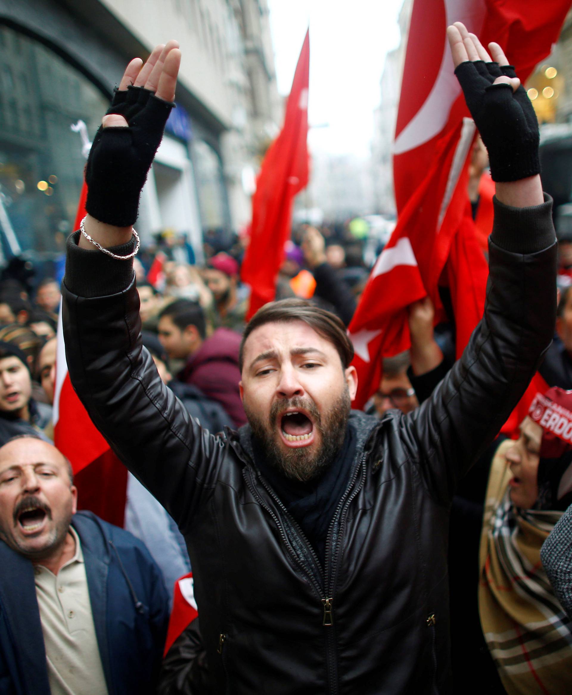 People shout slogans during a protest in front of the Dutch Consulate in Istanbul
