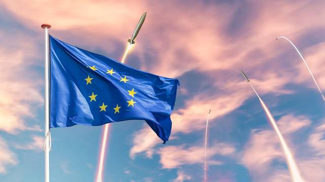 Official flag of the Europian Union in front of fired guided missile weapons