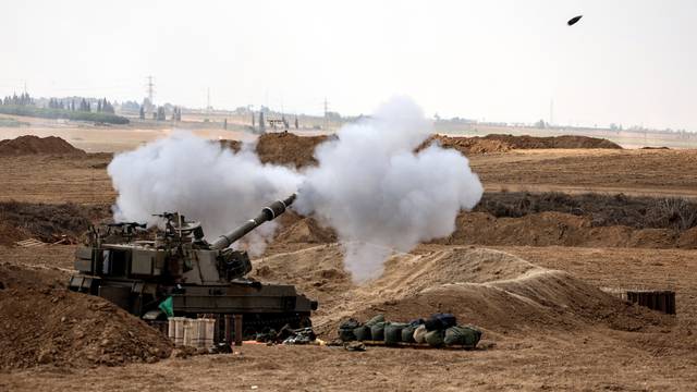 An Israeli tank fires near Israel's border with the Gaza Strip, in southern Israel