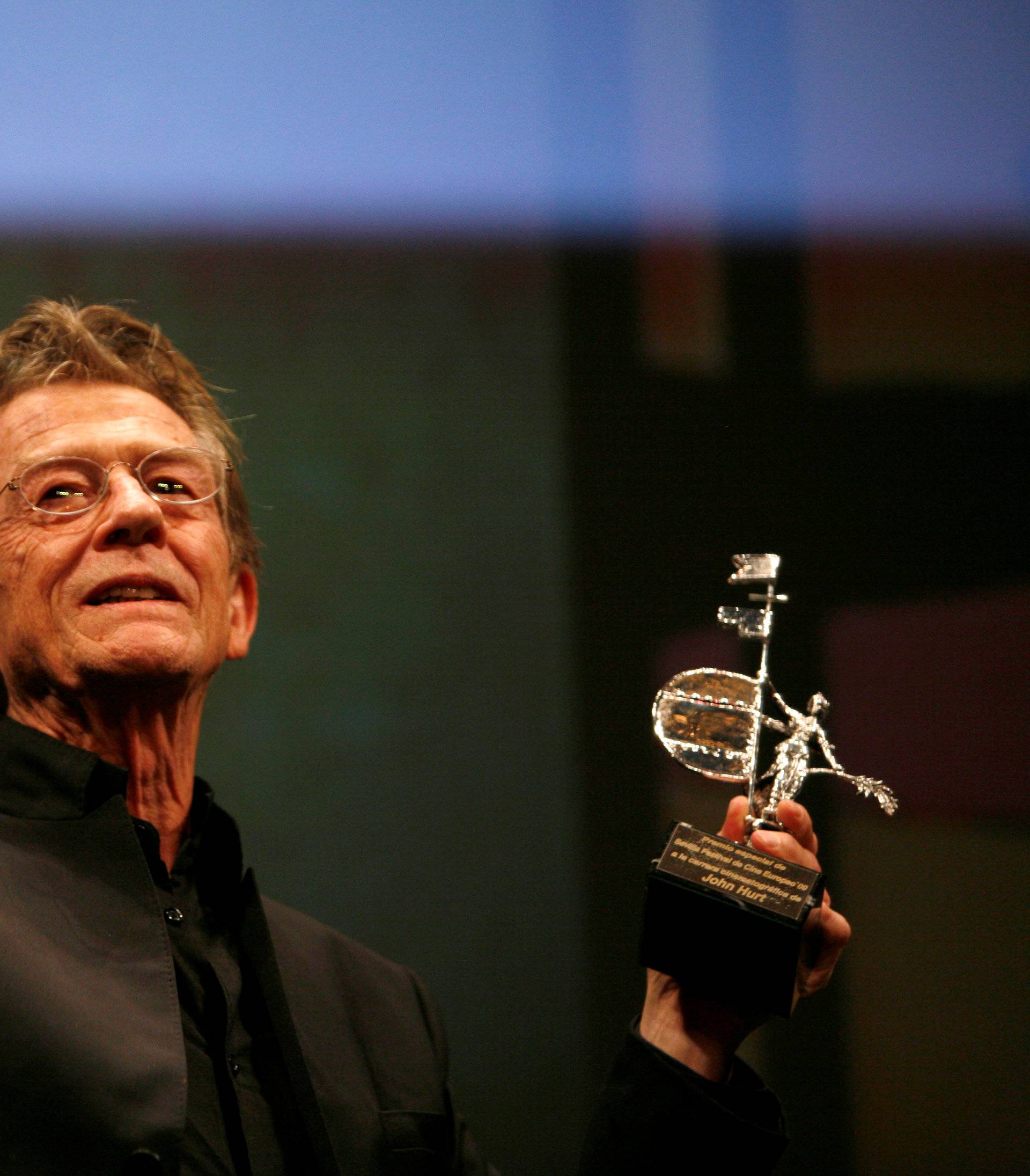 FILE PHOTO: British actor John Hurt holds the Gold Giraldillo Award as a tribute to his career during Sevilla European film festival in Seville