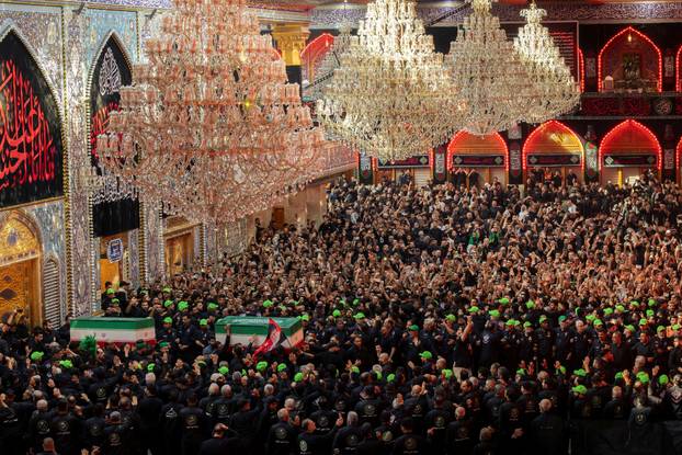 Mourners carry the coffins of family members of Iran’s late Supreme Leader Ayatollah Ali Khamenei, inside the shrine of Imam Abbas during funeral ceremonies in Karbala