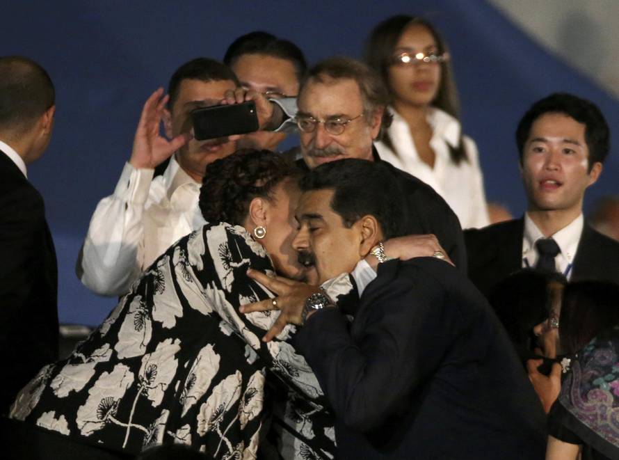 Colombia's former Senator Cordoba and Venezuelan President Maduro embrace as they attend a massive evening tribute to Cuba's late President Castro in Havana