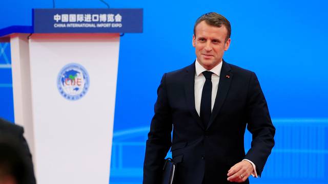 French President Emmanuel Macron returns to his seat following his speech at the opening ceremony of the second China International Import Expo (CIIE) in Shanghai