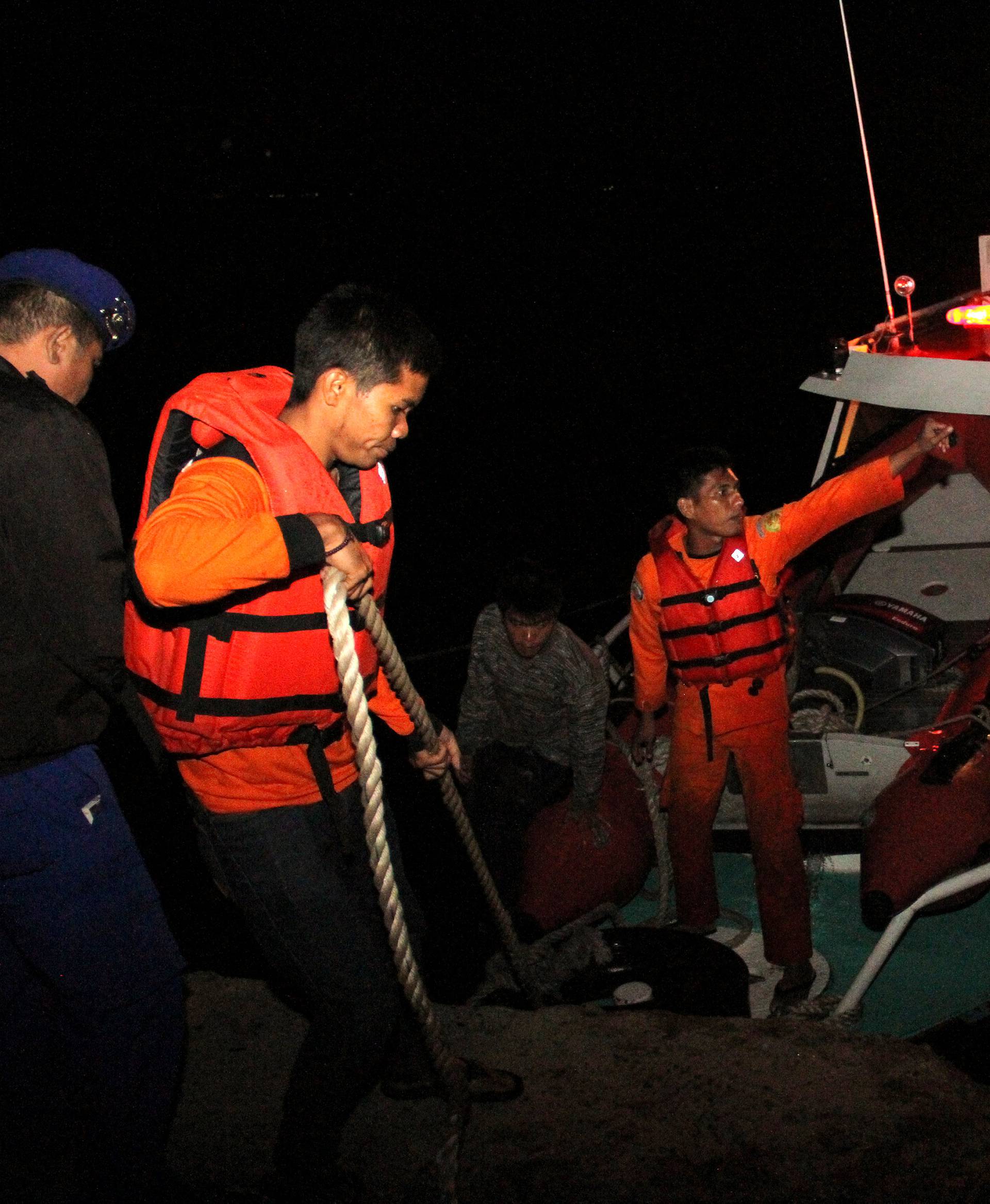 Search and rescue workers are seen on a boat used in the search for passengers from the Sinar Bangun ferry that sank in Lake Toba in Simalungun, North Sumatra