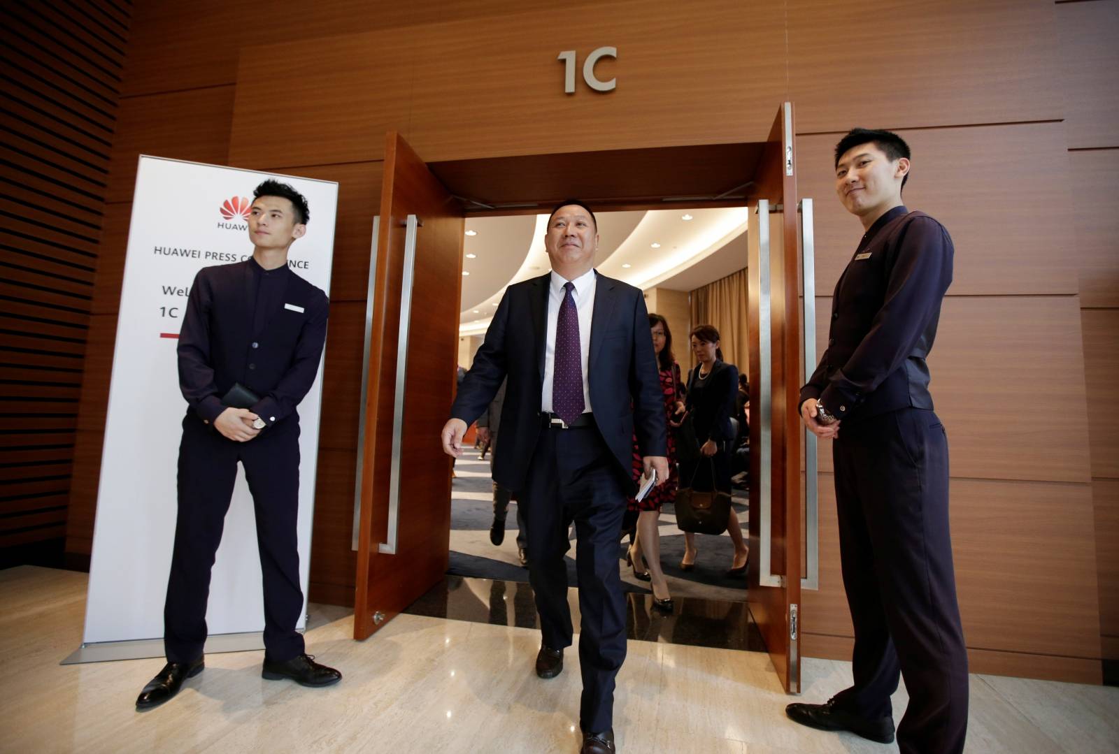 Huawei's Chief Legal Officer Song Liuping leaves after a news conference in Shenzhen