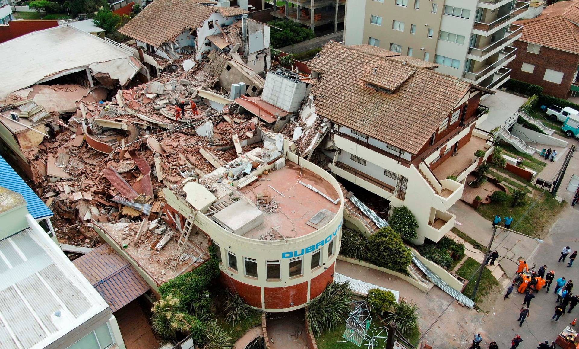 Firefighters search for trapped people after a hotel collapses in Villa Gesell