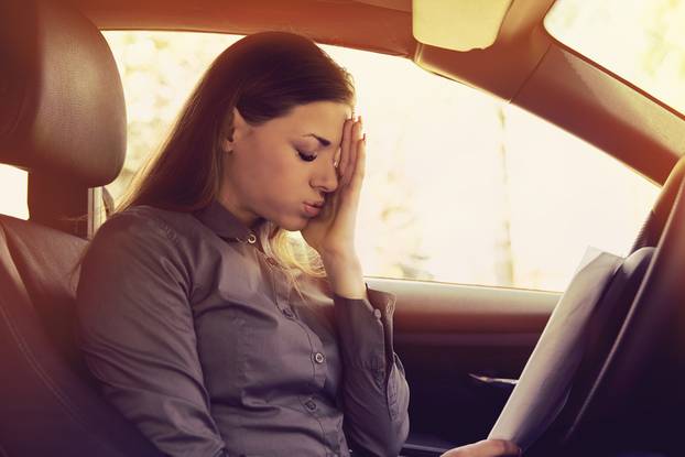 Stressed,Woman,Driver,With,Papers,Sitting,Inside,Her,Car