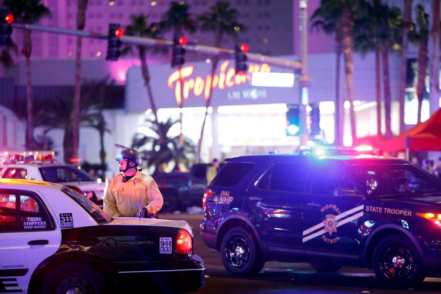 Las Vegas Metro Police officer stands by at a staging area in the intersection of Tropicana Avenue and Las Vegas Boulevard South after a mass shooting at a music festival on the Las Vegas Strip in Las Vegas