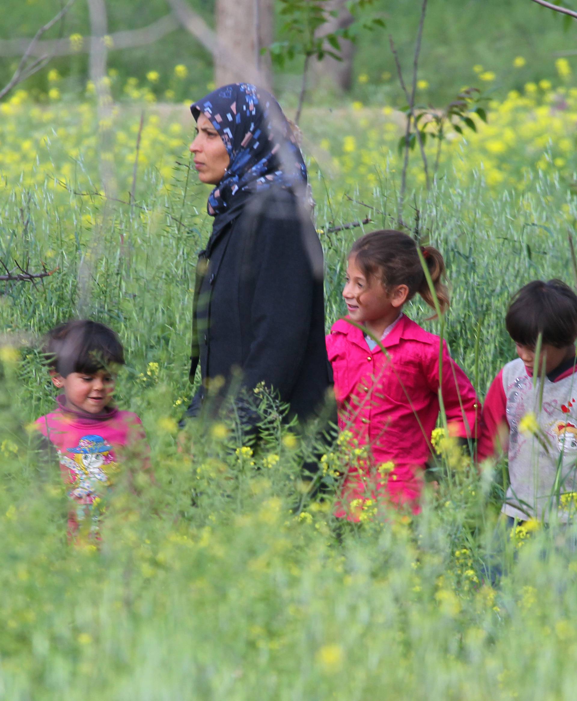 People who were evacuated from the two villages of Kefraya and al-Foua walk, after a stall in an agreement between rebels and Syria's army, at insurgent-held al-Rashideen