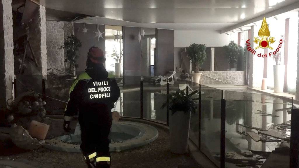 A firefighter walks inside Hotel Rigopiano in Farindola