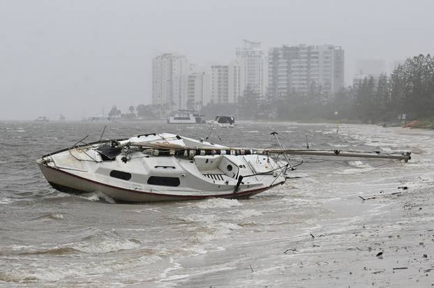 A yacht is washed on the shore in the Broadwater at Labrador after heavy rains and winds caused by Cyclone Alfred, on the Gold Coast