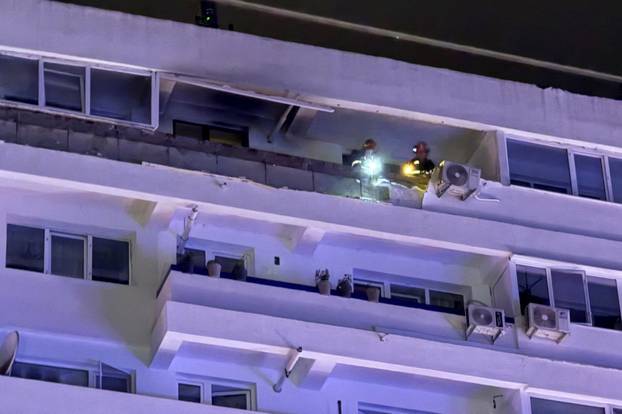 Firefighters and law enforcement work on the site of a explosion at a residential block of flats following a drone hit close to the border with Ukraine