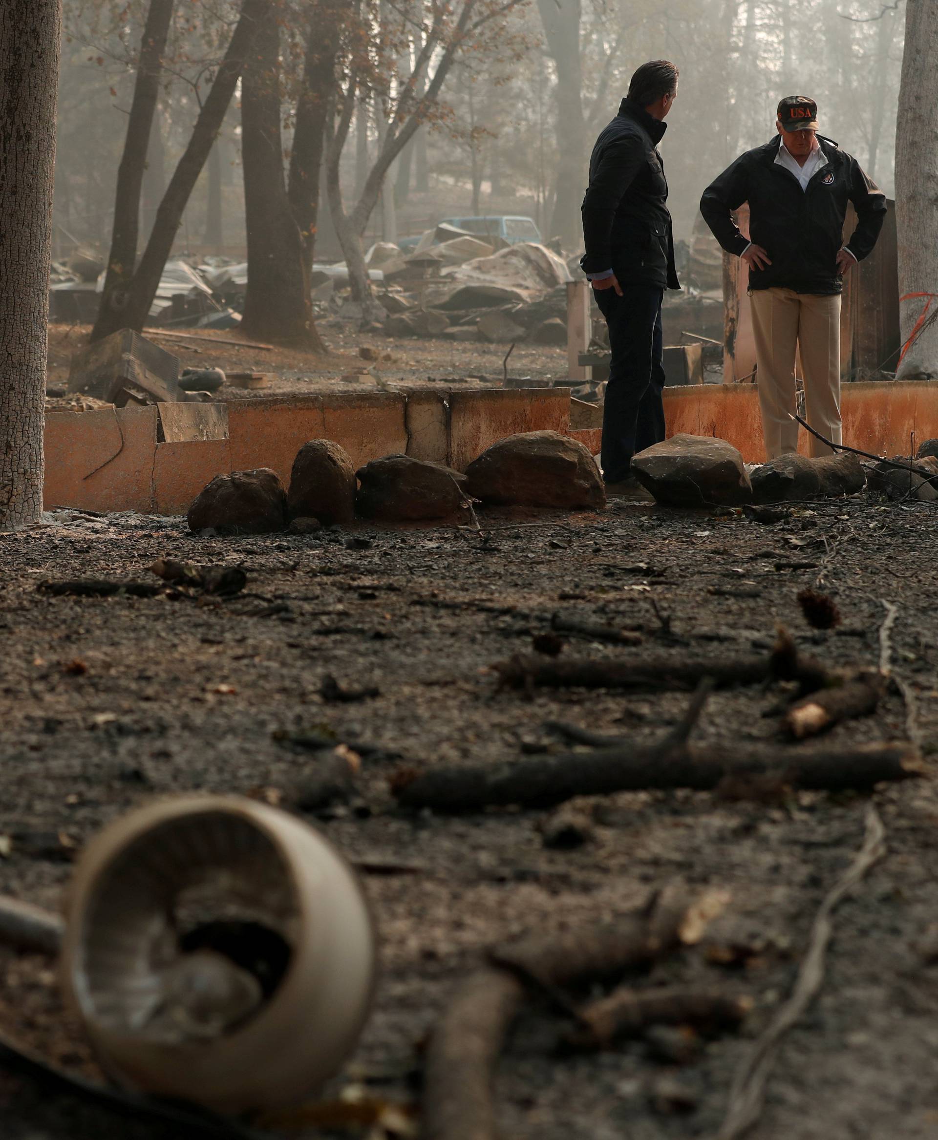 President Donald Trump visits the charred wreckage of Skyway Villa Mobile Home and RV Park with Governor-elect Gavin Newsom Brock Long Paradise Mayor Jody Jones and Governor Jerry Brown in Paradise California